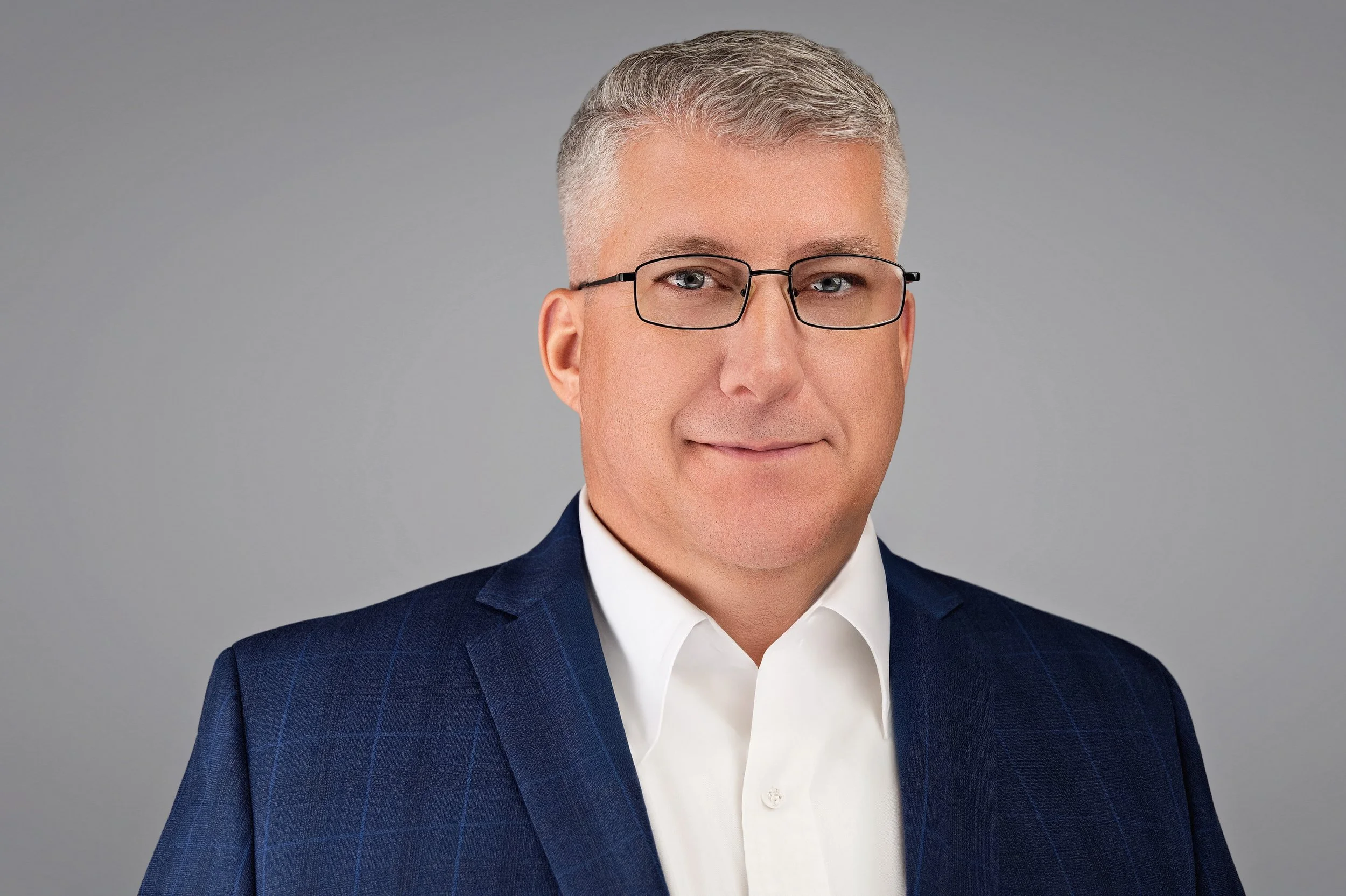 Executive headshot — man with glasses